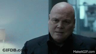 Bald Man In Black Suit Looking Serious GIF