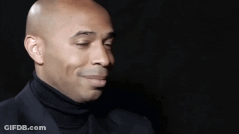 Bald Man In Black Turtleneck And Suit GIF
