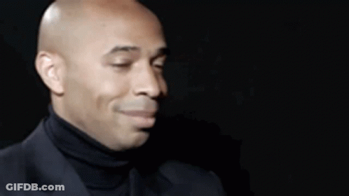 Bald Man In Black Turtleneck And Suit GIF