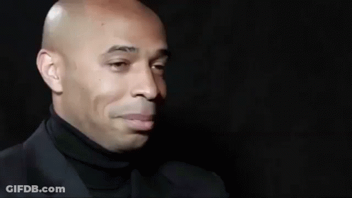 Bald Man In Black Turtleneck And Suit Smiling GIF