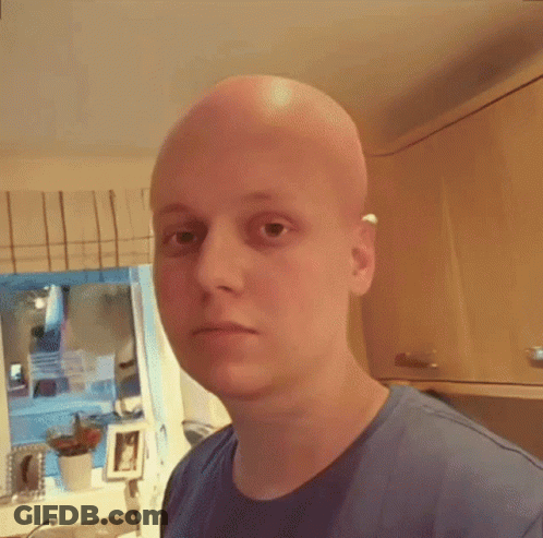 Bald Man In Blue Shirt Looking At Camera GIF