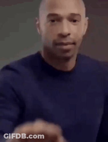 Bald Man In Blue Shirt Making Fist GIF