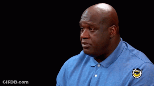 Bald Man In Blue Shirt With Shark Patch GIF