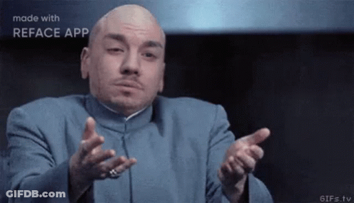 Bald Man In Blue Suit Making Gesture GIF