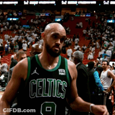 Bald Man In Celtics Jersey In Front Of Crowd GIF