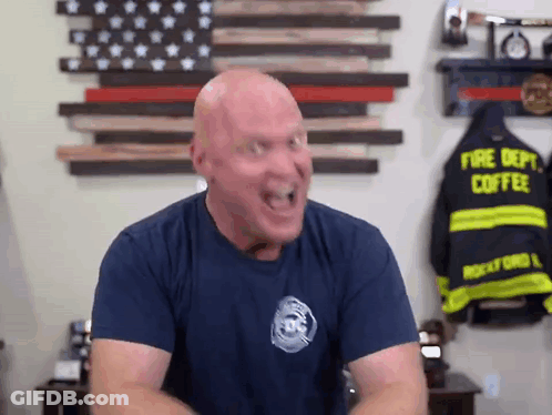 Bald Man In Fire Department Shirt Making Funny Face GIF