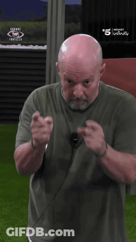 Bald Man In Front Of Grande Fortello Sign GIF