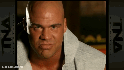 Bald Man In Front Of Ina Wrestling Ad GIF