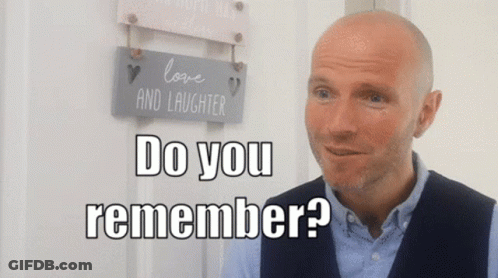 Bald Man In Front Of Love And Laughter Sign Saying Do You Remember GIF