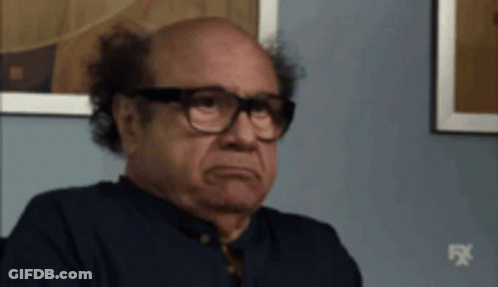 Bald Man In Glasses And Blue Shirt Sitting GIF