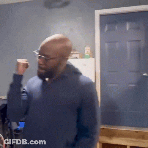 Bald Man In Glasses And Blue Sweater At Blue Door GIF