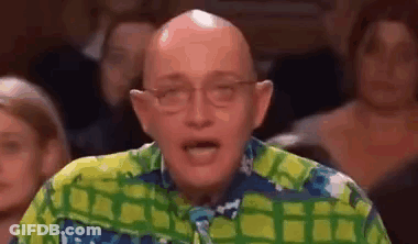 Bald Man In Glasses And Colorful Shirt Facing Crowd GIF