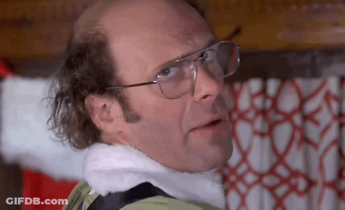Bald Man In Glasses And Santa Hat By Christmas Tree GIF