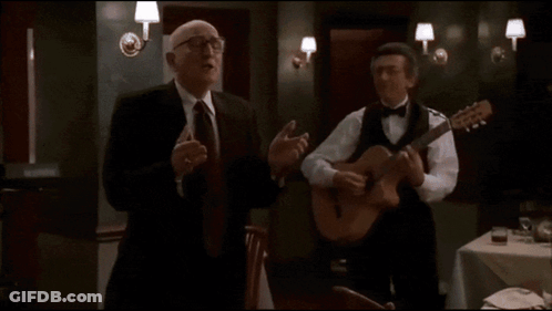 Bald Man In Glasses And Suit With Arms Outstretched GIF