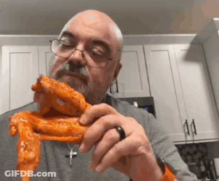 Bald Man In Glasses Holding Chicken Wing GIF