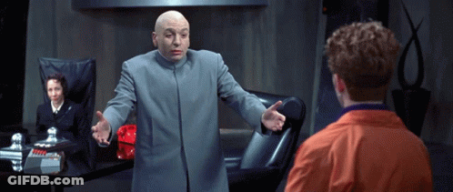 Bald Man In Gray Coat Talks To Man In Orange Jacket GIF