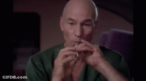 Bald Man In Green Shirt Smoking Cigarette GIF