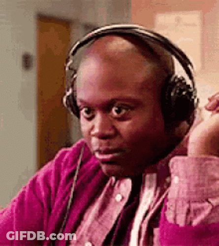 Bald Man In Headphones And Pink Shirt On Couch GIF