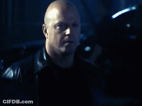 Bald Man In Leather Jacket Looking At Camera GIF