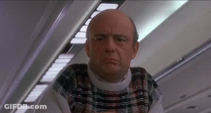 Bald Man In Plaid Sweater On Airplane GIF