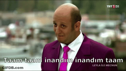 Bald Man In Purple Suit Saying Taam Taam GIF