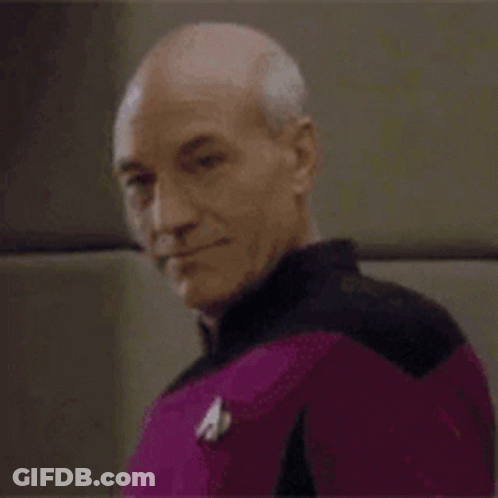 Bald Man In Purple Uniform Smiling GIF