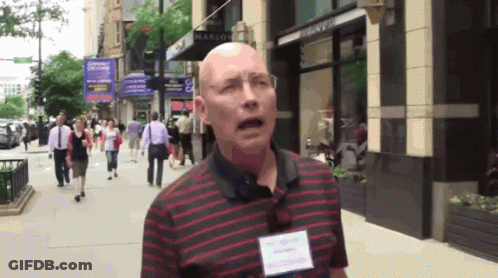 Bald Man In Red And Black Striped Shirt In Front Of Marlow Store GIF