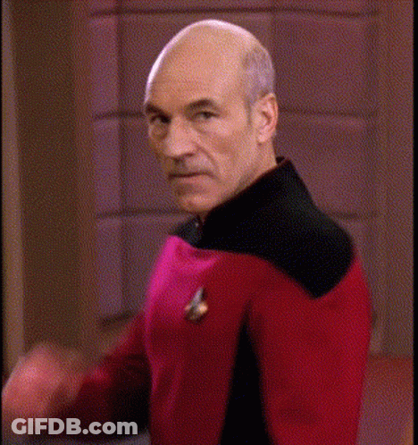 Bald Man In Red And Black Uniform Making Funny Face GIF
