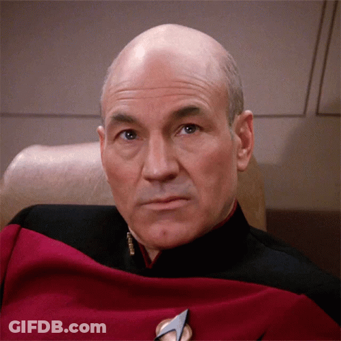 Bald Man In Red And Black Uniform With Commander Badge GIF