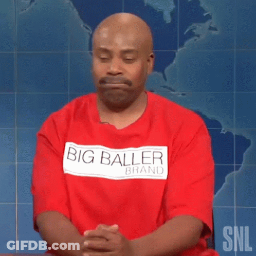 Bald Man In Red Big Baller Brand Shirt Sitting With Hands Folded GIF