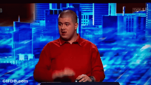 Bald Man In Red Shirt In Front Of TV GIF
