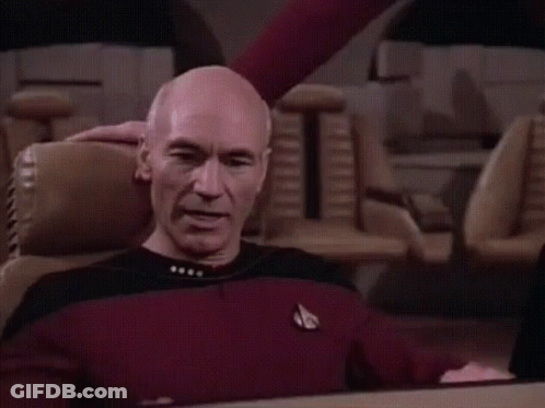 Bald Man In Red Shirt Sitting With Arms Outstretched GIF
