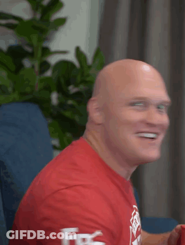 Bald Man In Red Shirt Smiling Fire GIF