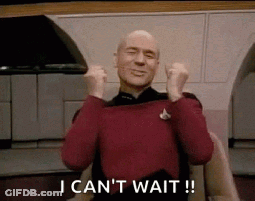 Bald Man In Red Sweater Holding Fists In Air GIF