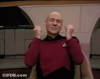 Bald Man In Red Sweater Sitting With Arms In Air GIF