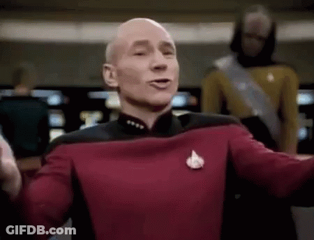 Bald Man In Red Uniform Arms Outstretched Before Crowd GIF