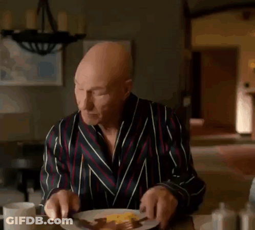 Bald Man In Robe Looking At Phone Saying Holy Fucking GIF