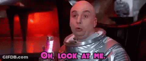 Bald Man In Space Suit Holding Lamp GIF