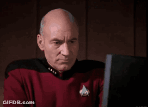 Bald Man In Star Trek Uniform Typing On Laptop GIF