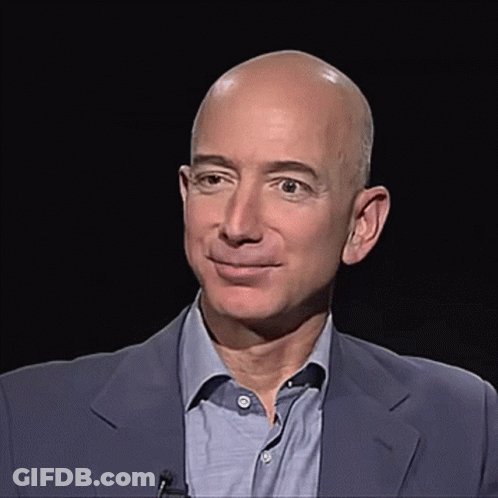 Bald Man In Suit And Blue Shirt Smiling GIF