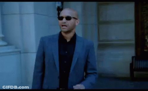 Bald Man In Suit And Sunglasses Walking GIF