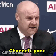 Bald Man In Suit And Tie At Mic GIF