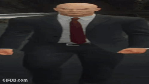 Bald Man In Suit And Tie In Dark Room GIF