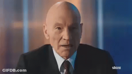 Bald Man In Suit And Tie Looking At Camera GIF