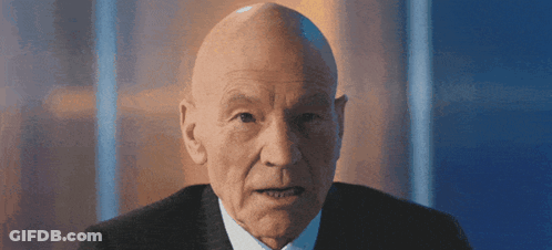 Bald Man In Suit And Tie Looking At Camera GIF
