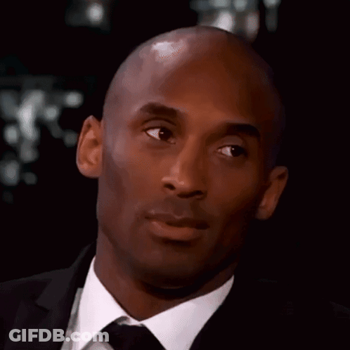 Bald Man In Suit And Tie Looking At Camera GIF