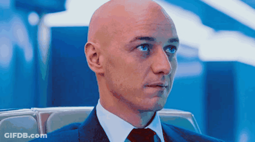Bald Man In Suit And Tie Looking Left GIF