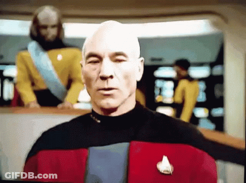 Bald Man In Suit And Tie Looking Left GIF
