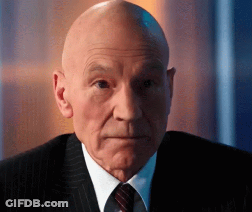 Bald Man In Suit And Tie Looking To Side GIF