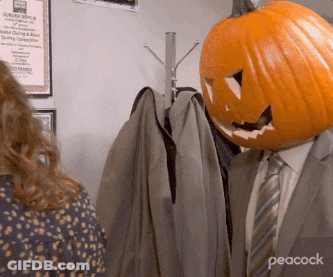 Bald Man In Suit And Tie Sitting In Chair GIF